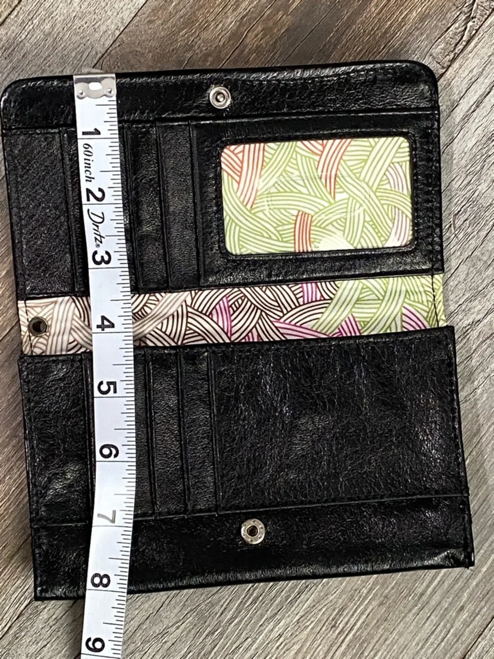 The Sak Black Quilted Eyelet Trifold Leather Wallet with Logo Plaque